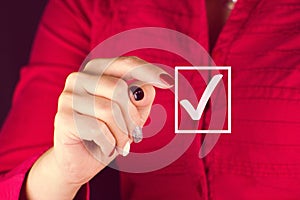 Business woman shows a forefinger in front of her on the selected Yes check box.