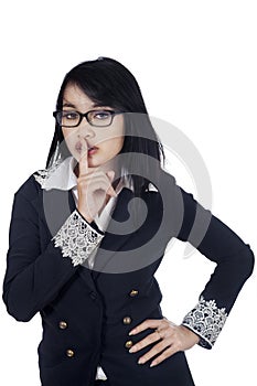 Business woman shows silence sign