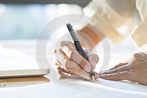 Business woman signing a contract document making a deal.