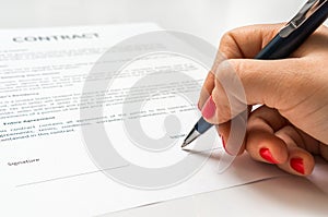 Business woman signing contract document in office