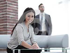 Business woman signs documents in a modern office.