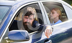 Business woman sit on backseat while bearded driver sit in front. Car with open windows and passenger. Business lady