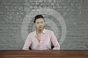 Business woman sitting behind an empty desk, he is bankrupt