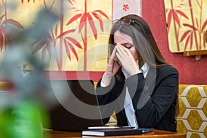 The business woman sitting in front of a laptop