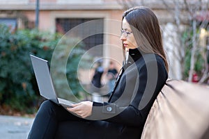 The business woman sitting in front of a laptop