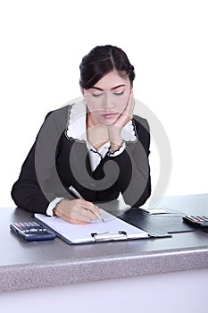 Business woman sitting on her desk holding a pen working with do