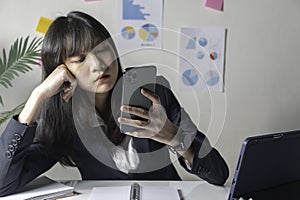 Business woman sitting in her office and checking the company`s earnings