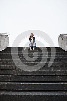 Business woman, sitting and stairs in portrait, low angle and mockup space in city, metro and relax on break. Young