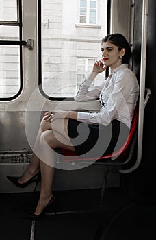 Business woman sitting in the tram