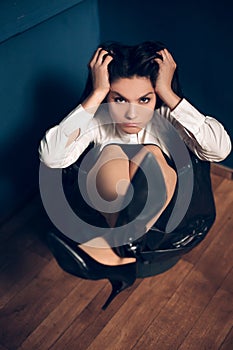 Business woman sitting in trash bin.