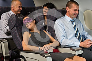 Business woman sleep during flight airplane cabin photo