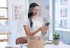 Business woman with smartphone, chat and typing with social media, communication and connectivity in workplace. Female