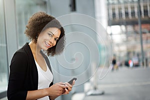 Business woman smiling with cellphone