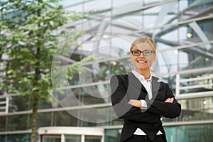 Business woman smiling with glasses in the city