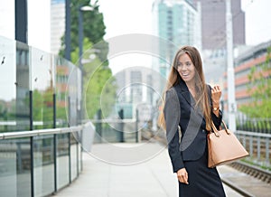 Business woman smiling at outdoor train station