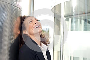 Business woman smiling outside office building