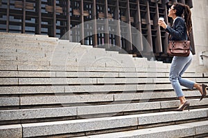 Business woman, stairs and coffee break with commute and work in city for job growth. Urban, lawyer and company steps