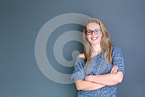 Business woman standing against gray background