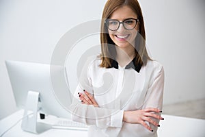 Business woman standing with arms folded