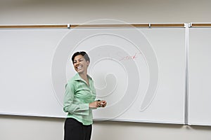 Business Woman Standing In Front Of Whiteboard