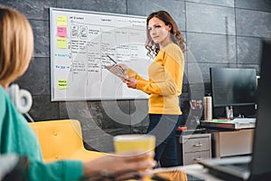 Business woman standing in front of the whiteboard photo