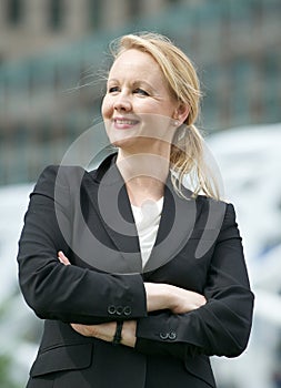 Business woman standing outside the office with arms crossed