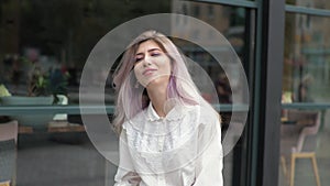 Business woman stands against the background of window outside portrait Smiling