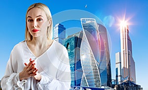 Business woman stands over cityscape background.