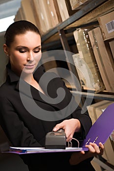 Business woman stock counting in warehouse