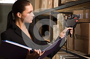 Business woman stock counting in warehouse