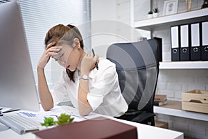 Business woman is stressed from work, she is at the office. She felt tired and wanted to relax