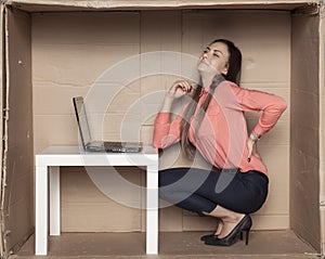 Business woman struggles with backache, uncomfortable office