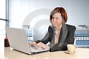 Business woman suffering stress working at office computer desk worried