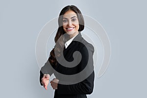 Business woman in suit smiling friendly offering handshake as greeting and welcoming. Successful business. Businesswoman