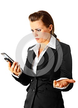 Business woman surprisedly looking at mobile phone