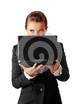 Business woman suspicious looks out from laptop