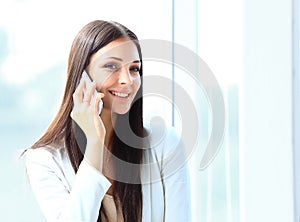 Business woman talking on cell phone while looking at copyspace