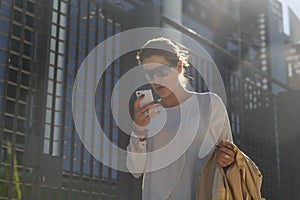 Business woman talking on her mobile phone, while walking down the street