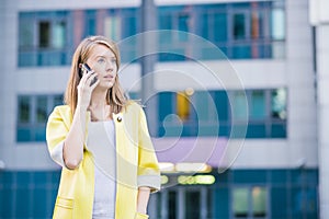 Business woman talking on her mobile smart phone