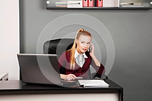 Business woman talking on mobile phone in office