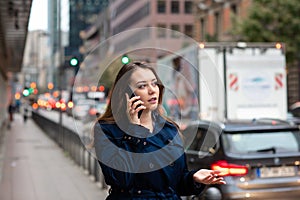 Business woman talking on mobile walking down city street. Half length photo. Germany, Frankfurt