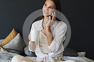 Business woman is talking on phone, negotiating, making an appointment with friends.