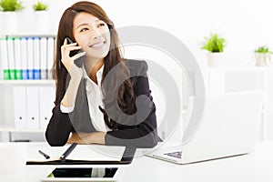 Business woman talking on the phone in office