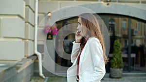 Business woman talking phone outside. Woman walking with smartphone outdoors