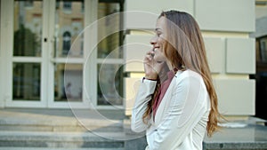 Business woman talking phone outside. Woman walking with smartphone outdoors