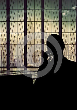 Business woman talking at the phone silhouette against building