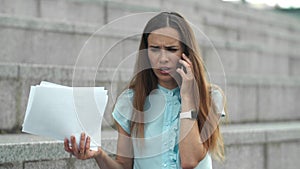 Business woman talking on smartphone in city. Woman arguing in mobile phone