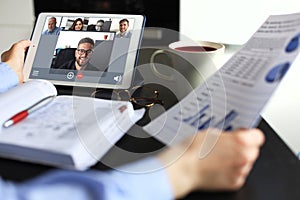 Business woman talking to her colleagues in video conference. Business team working from home using digital tablet