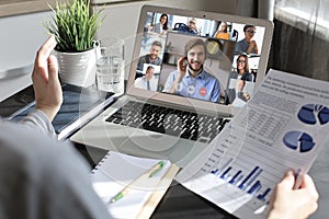 Business woman talking to her colleagues in video conference. Business team working from home using laptop