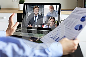 Business woman talking to her colleagues in video conference. Business team working from home using laptop.